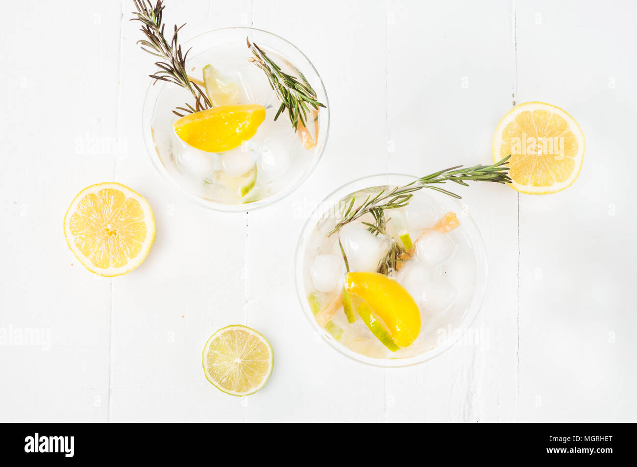 Gin, lemon, rosemary fizz, cocktail with honey and fresh herbs on a
