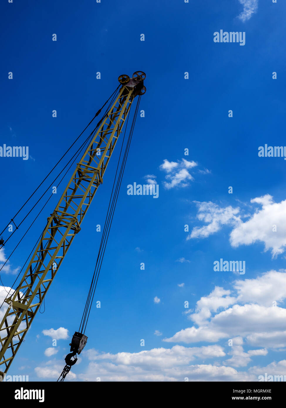 Crane on blue sky background with clouds Stock Photo - Alamy