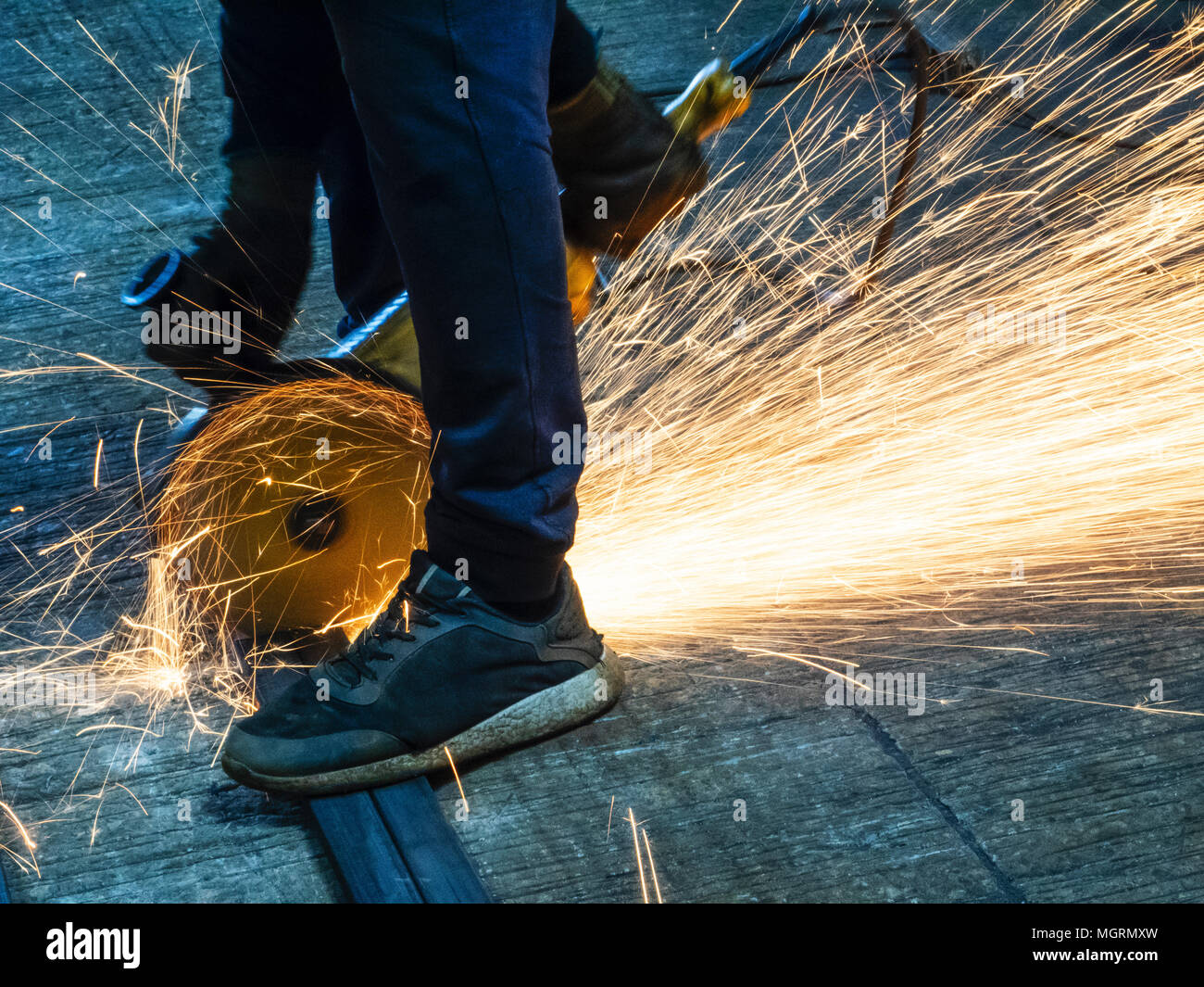 Man cuts metal with angle grinder Stock Photo Alamy