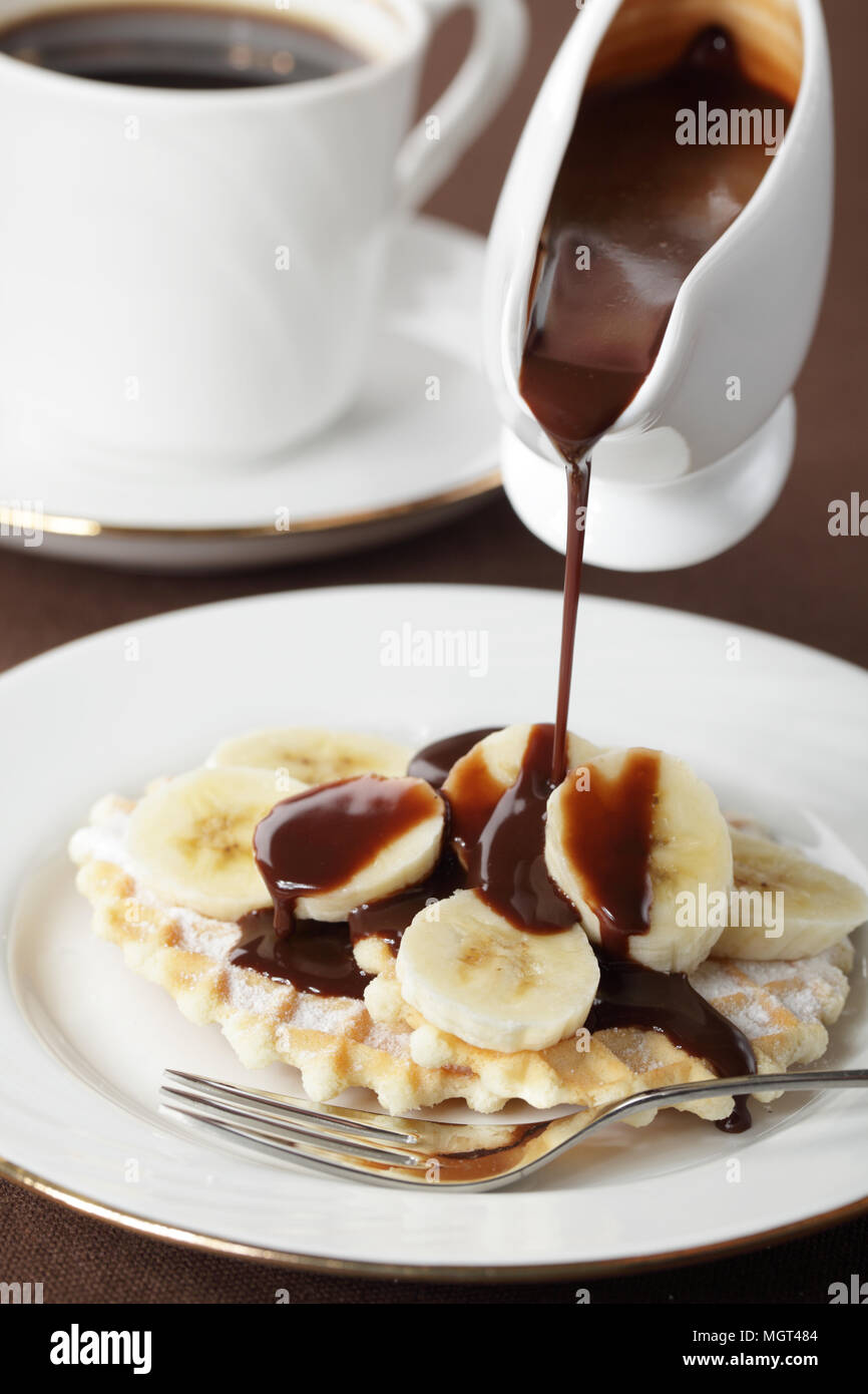 Waffle with banana under chocolate sauce closeup Stock Photo - Alamy