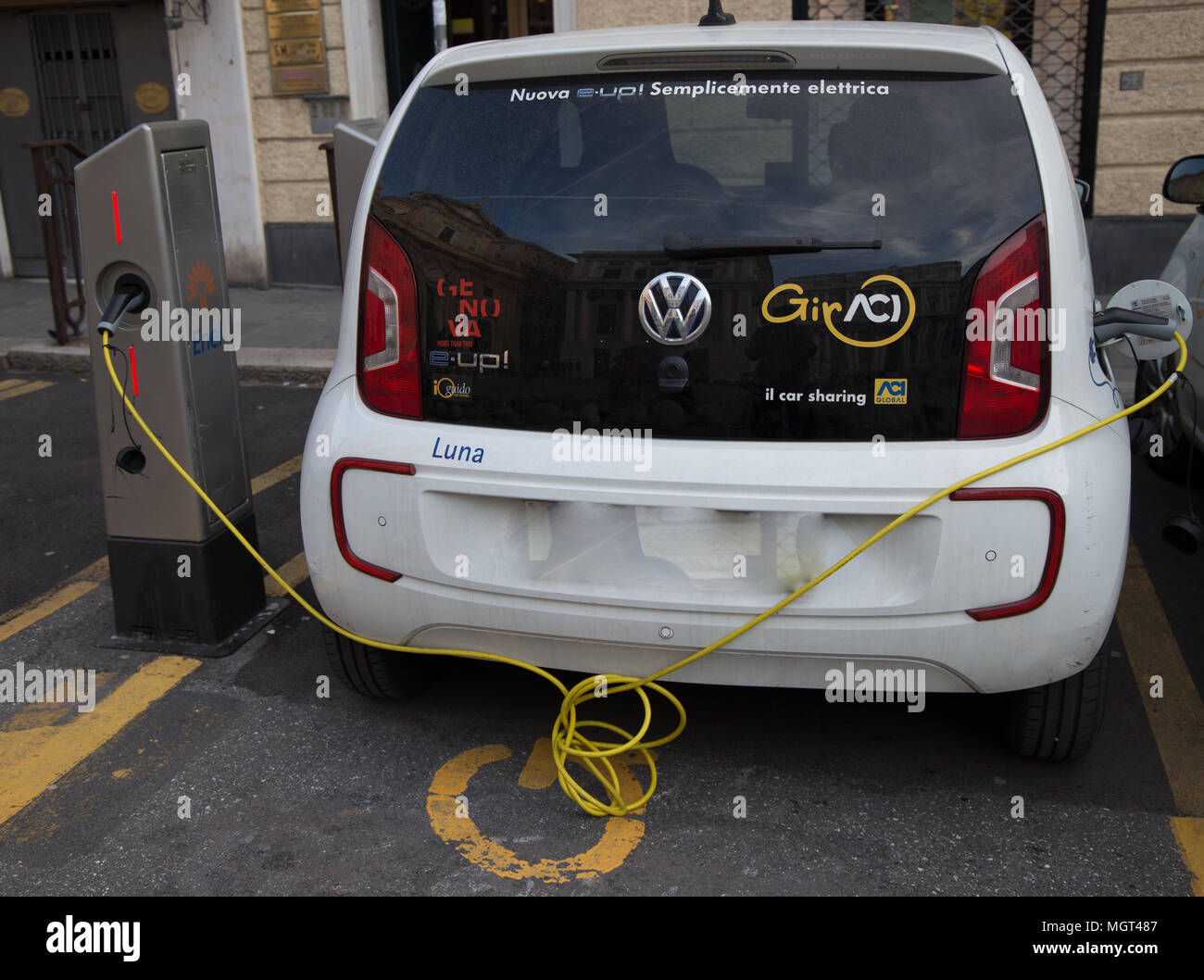 GENOA (GENOVA), ITALY, APRIL 16, 2018 - Volkswagen e-Up plug-in hybrid electric car stands by charging station, in Genoa (Genova), Italy. Stock Photo