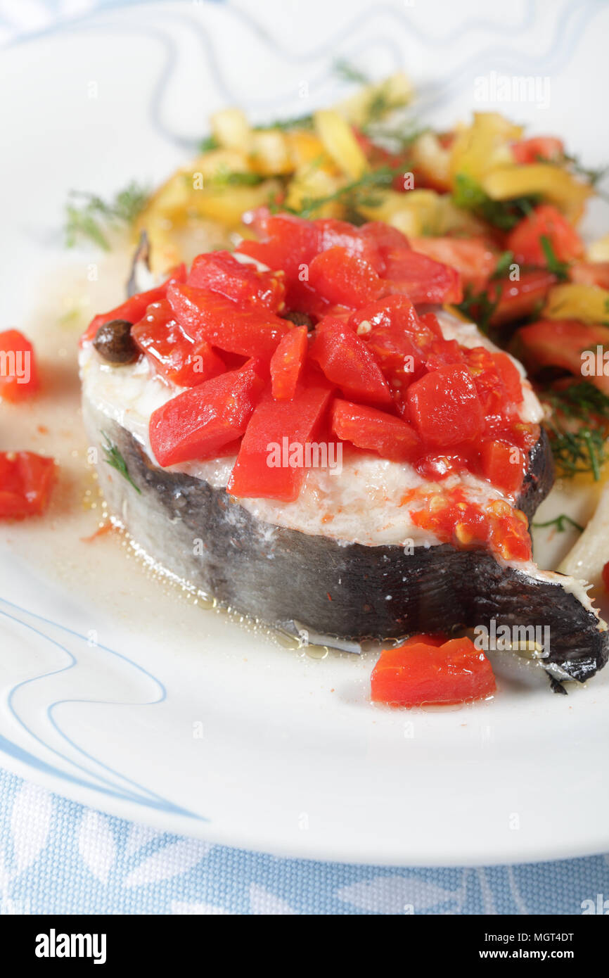 Slice of baked conger with vegetables closeup Stock Photo