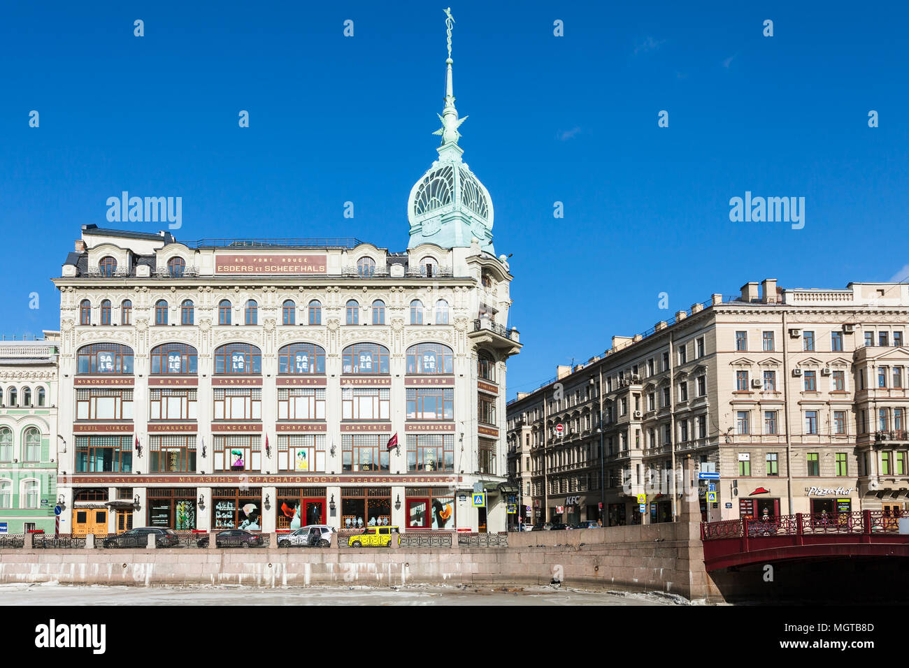 SAINT PETERSBURG, RUSSIA - MARCH 17, 2018: facade of Trading House of Esders and Schieifals near Red Bridge on Moyka River embankment in spring. This  Stock Photo