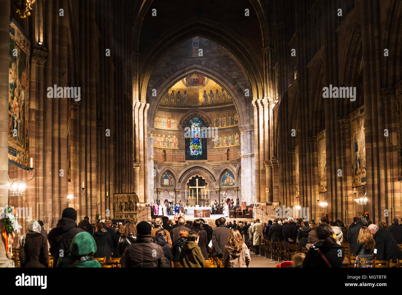 STRASBOURG, FRANCE - DECEMBER 11, 2011: people on night church service in The Cathedral of Notre Dame of Strasbourg city (Strassburger Muenster) durin Stock Photo