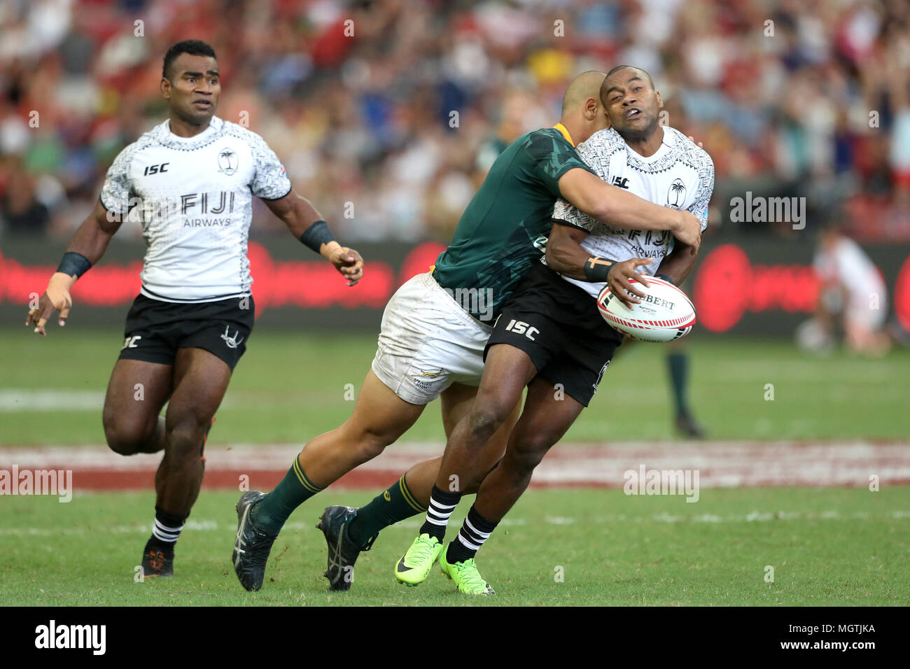 Singapore. 29th Apr, 2018. Alasio Sovita Naduva of Fiji (right) is tackled by Zain Davids of South Africa during the Cup Semi Final match between Fiji and South Africa at the Rugby Sevens tournament at the National Stadium. Singapore. Credit: Paul Miller/ZUMA Wire/Alamy Live News Stock Photo