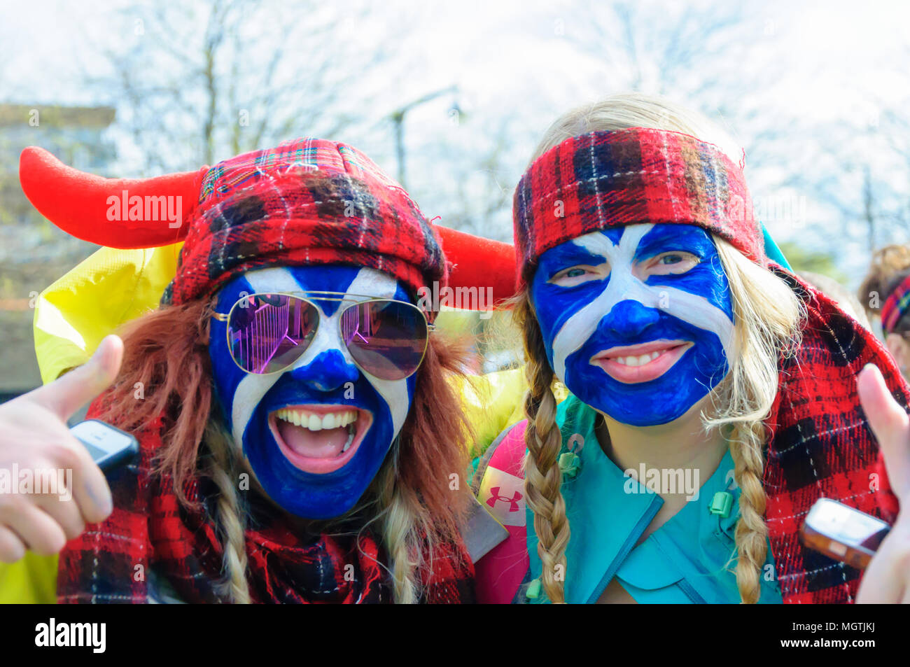 Glasgow, Scotland, UK. 29th April, 2018. Two smiling girls with the Scottish Flag painted onto their faces and wearing tartan headdresses at the start of the Kiltwalk Glasgow 2018, a charity event where walkers have three distances to choose from, a Mighty Stride (23 miles), a Big Stroll (14 miles) or the Wee Wander (6 miles). This year involved 10,000 walkers and raised two million pounds for 600 charities. Credit: Skully/Alamy Live News Stock Photo