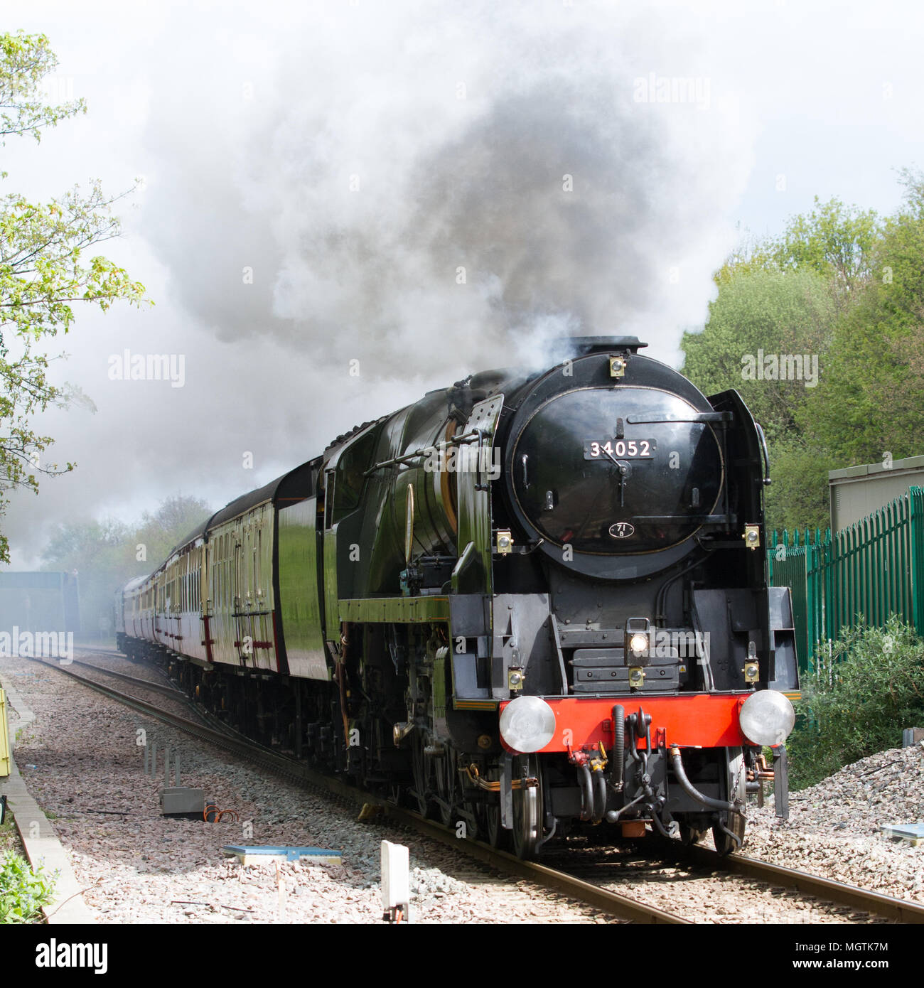 Wrexham, North Wales, UK. 29th April, 2018. Steam locomotive 34052 Lord Dowding speeds towards the foot of Gresford Bank between Chester and Wrexham General hauling a charter train for Britains newest train company, Locomotive Services Ltd. Credit: Charles Allen/Alamy Live News Stock Photo