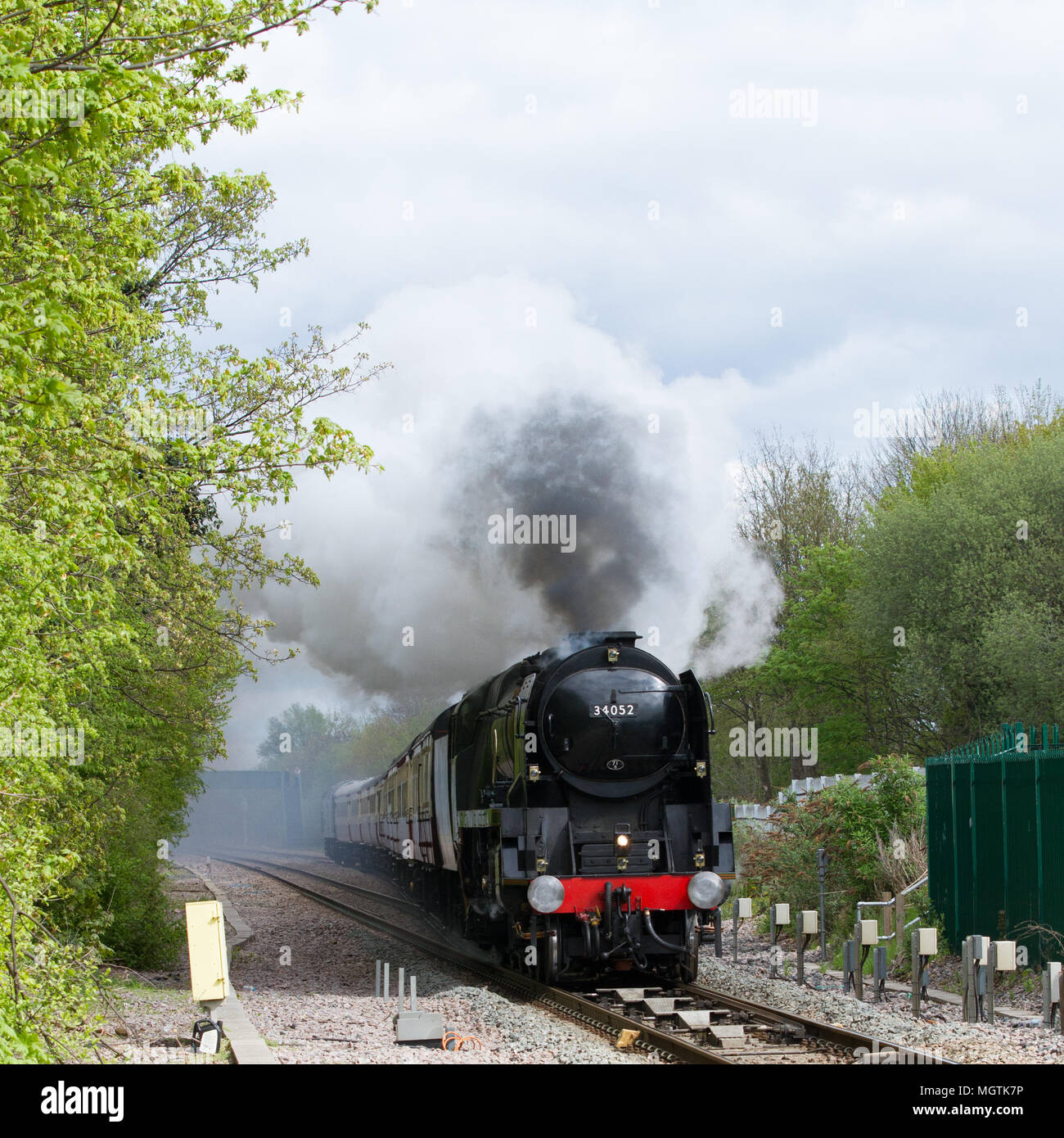 Wrexham, North Wales, UK. 29th April, 2018. Steam locomotive 34052 Lord Dowding speeds towards the foot of Gresford Bank between Chester and Wrexham General hauling a charter train for Britains newest train company, Locomotive Services Ltd. Credit: Charles Allen/Alamy Live News Stock Photo
