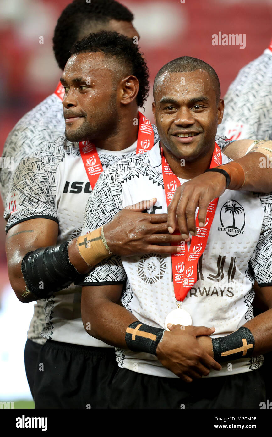 Singapore. 29th Apr, 2018. Eroni Say l embraces Alasio Sovita Naduva after receiving their medals after winning the Cup Final match between Fiji and Australia at the Rugby Sevens tournament at the National Stadium. Singapore. Credit: Paul Miller/ZUMA Wire/Alamy Live News Stock Photo