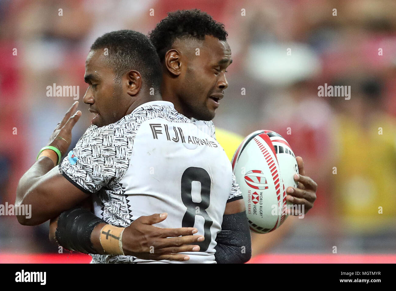 Singapore. 29th Apr, 2018. Waisea Nacuqu (left) of Fiji is embraced by Eroni Say after scoring a try during the Cup Final match between Fiji and Australia at the Rugby Sevens tournament at the National Stadium. Singapore. Credit: Paul Miller/ZUMA Wire/Alamy Live News Stock Photo
