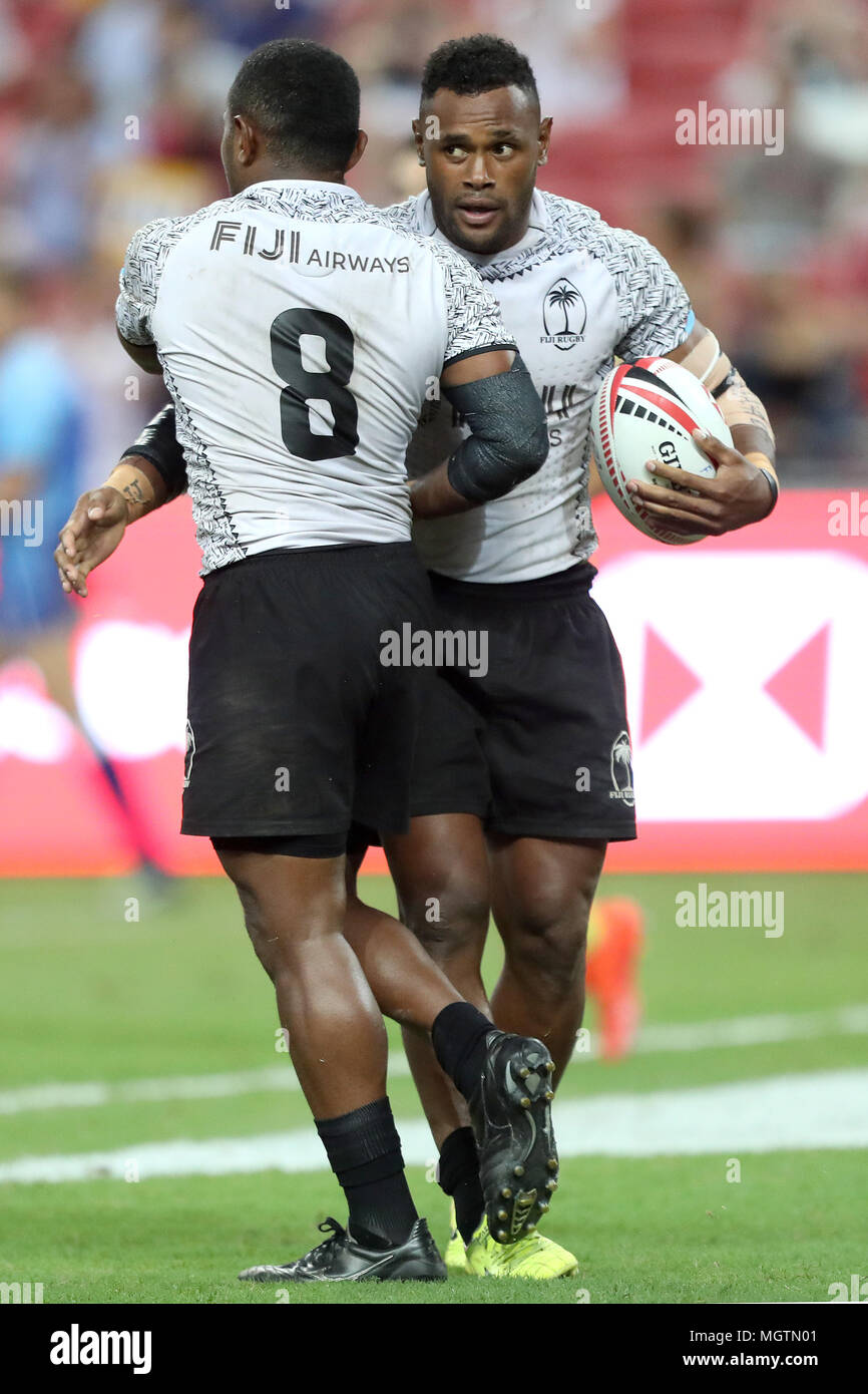 Singapore. 29th Apr, 2018. Waisea Nacuqu (left) of Fiji is embraced by Eroni Say after scoring a try during the Cup Final match between Fiji and Australia at the Rugby Sevens tournament at the National Stadium. Singapore. Credit: Paul Miller/ZUMA Wire/Alamy Live News Stock Photo