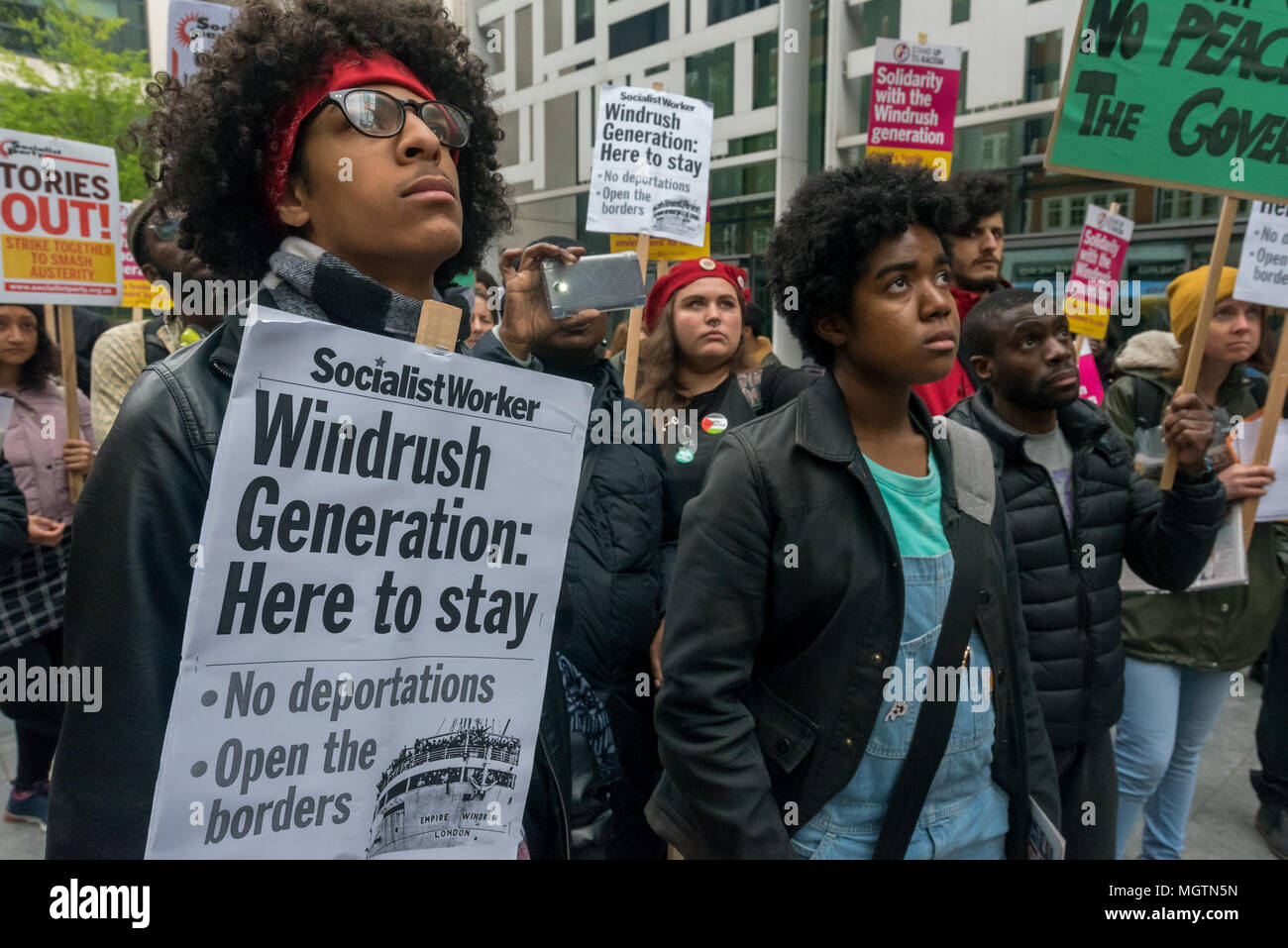 London, UK. 28 April 2018. People with placards at the protest outside the Home Office. The protest was called by an individual disgusted by the government's incompetence and deliberately targeted attack on legal immigrants. Organiser Sara Burke wrote that ''the government's abhorrent treatment of those from the Windrush generation is a national embarrassment'' and planned the march to the Home office to put pressure on them to keep their promises to these people. Credit: ZUMA Press, Inc./Alamy Live News Stock Photo