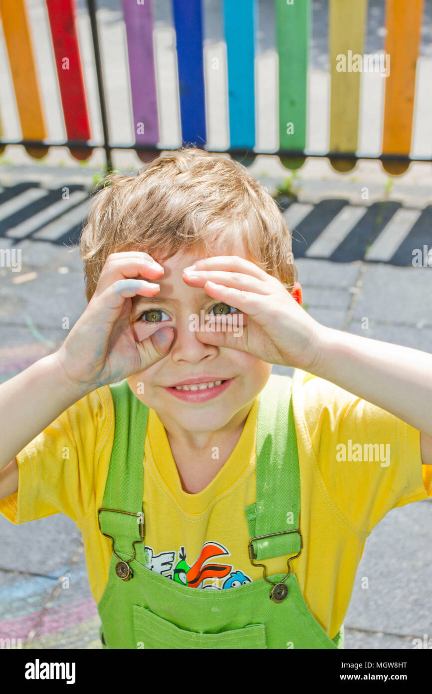 Boy. Portrait of cute boy kid in sunny day. Portrait of Happy blond child smiling. Boy looking at the camera with a handsome smile on his face. Summer Stock Photo