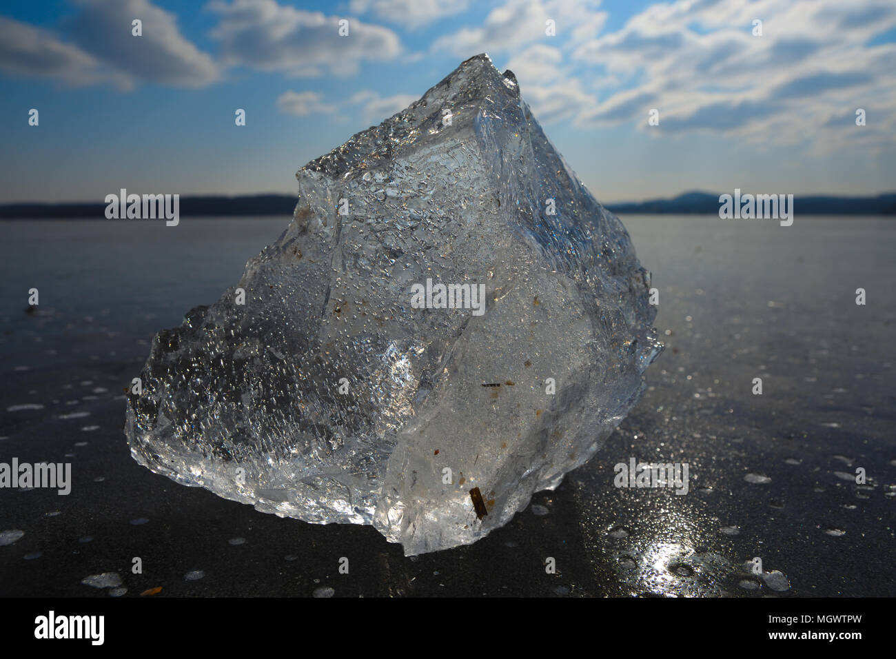 Natural ice skating rink outdoors broken pieces of shining ice. Air