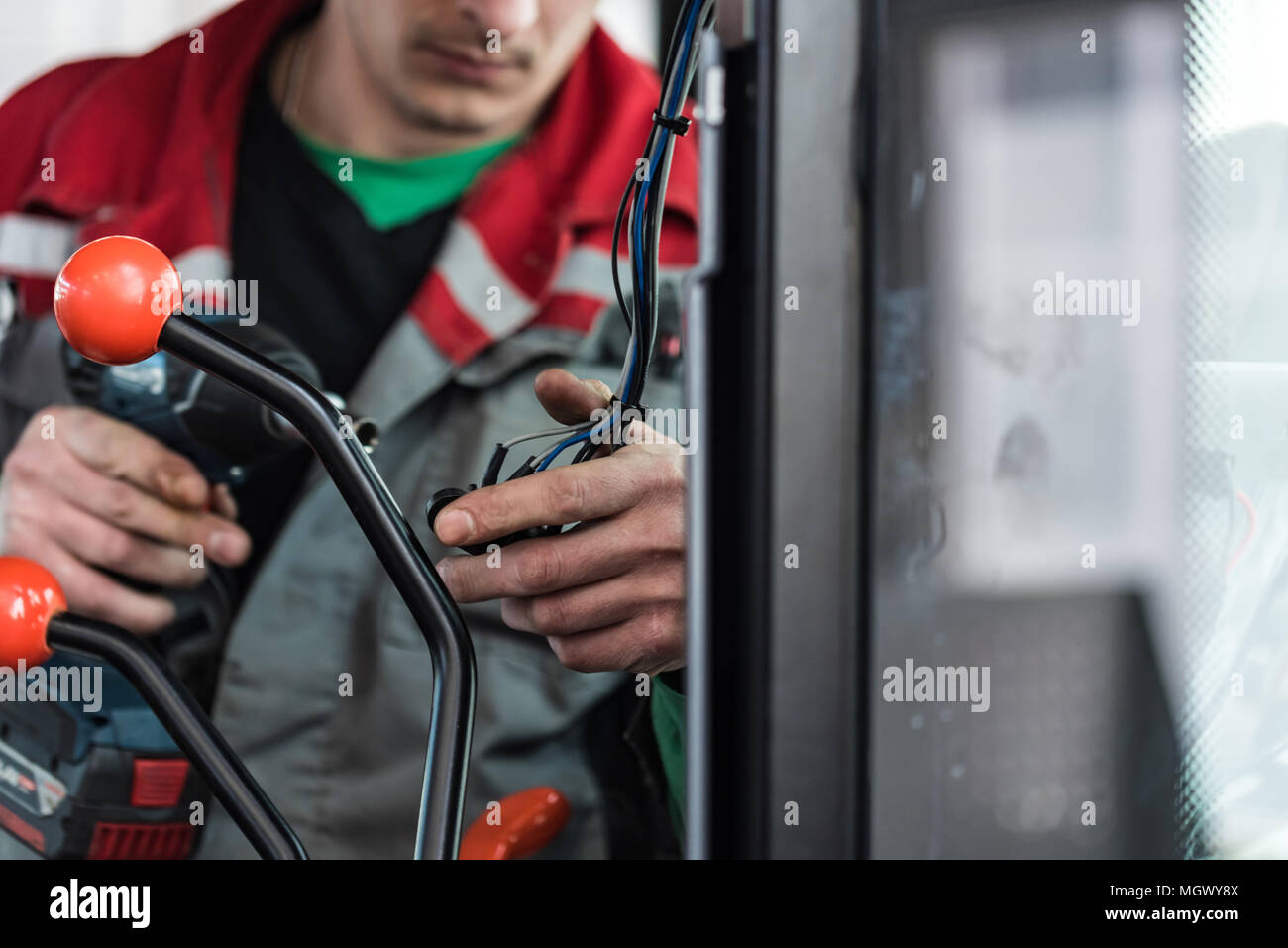 Industrial worker assembles agricultural equipment Stock Photo Alamy