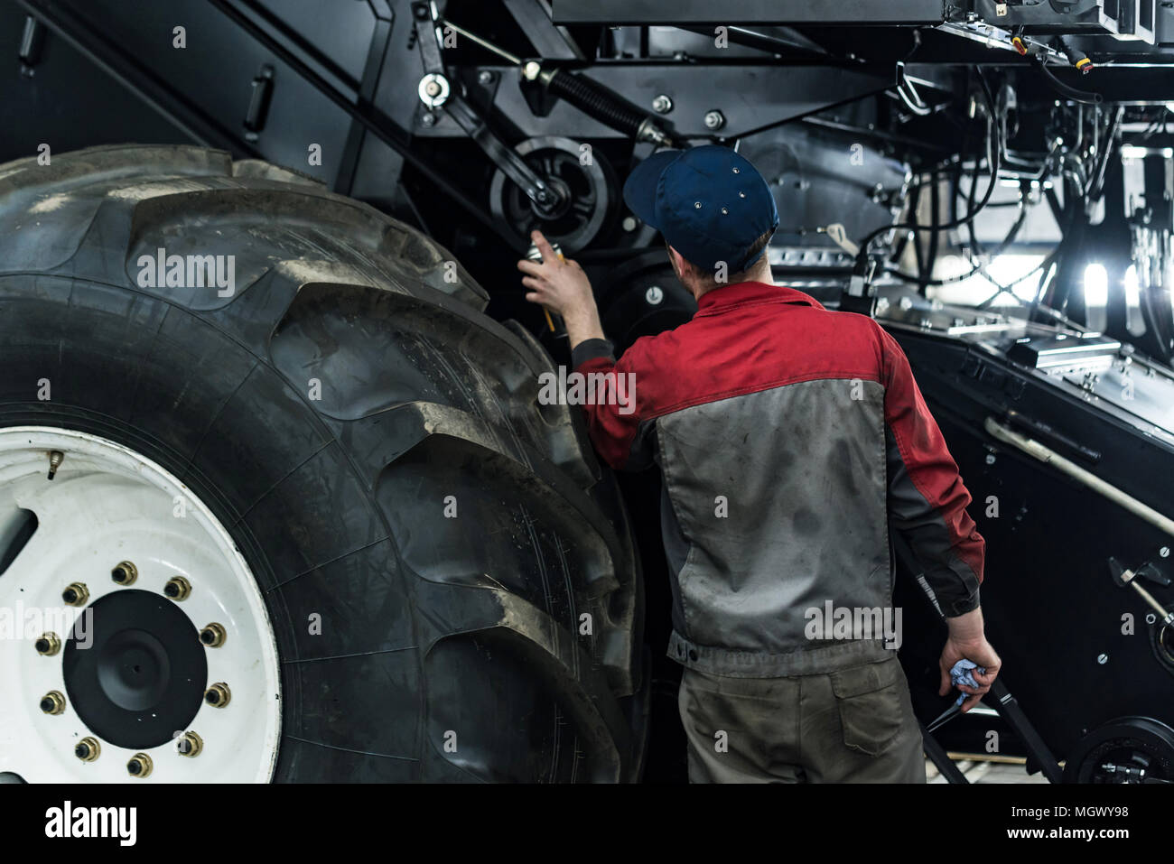 Industrial worker assembles agricultural equipment Stock Photo Alamy