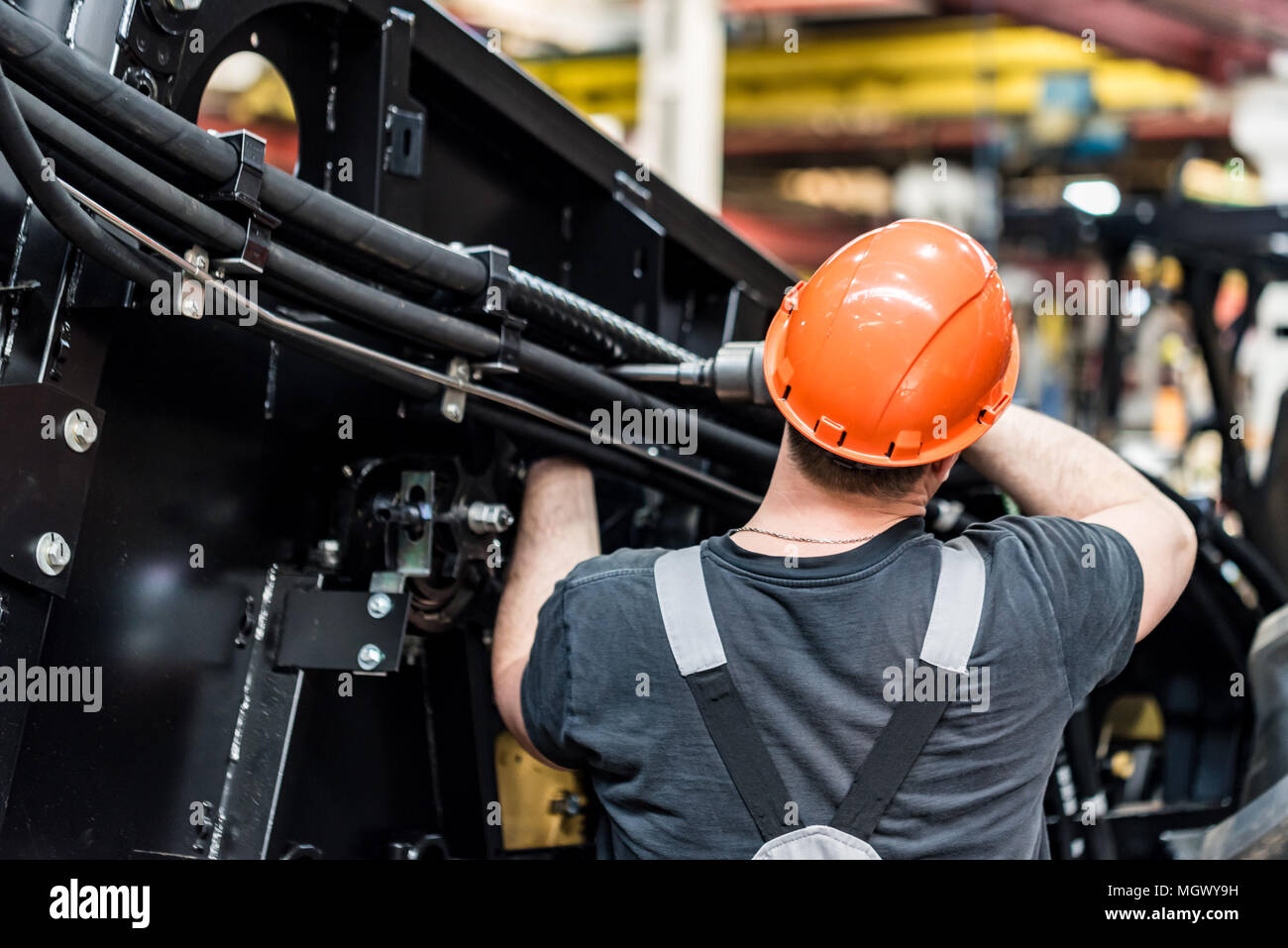 Industrial worker assembles agricultural equipment Stock Photo Alamy