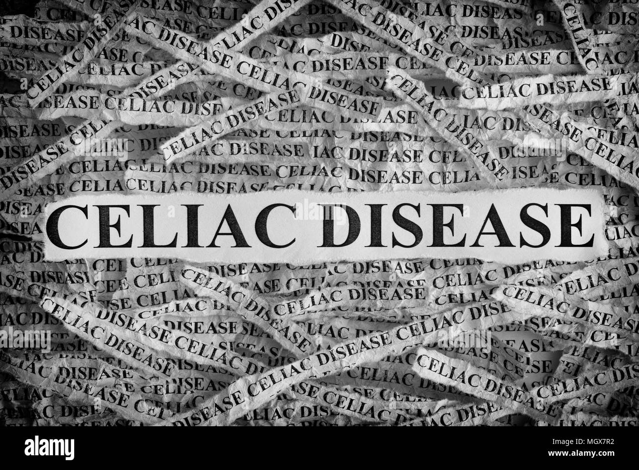 Celiac Disease. Torn pieces of paper with the words Celiac Disease. Concept Image. Black and White. Closeup. Stock Photo