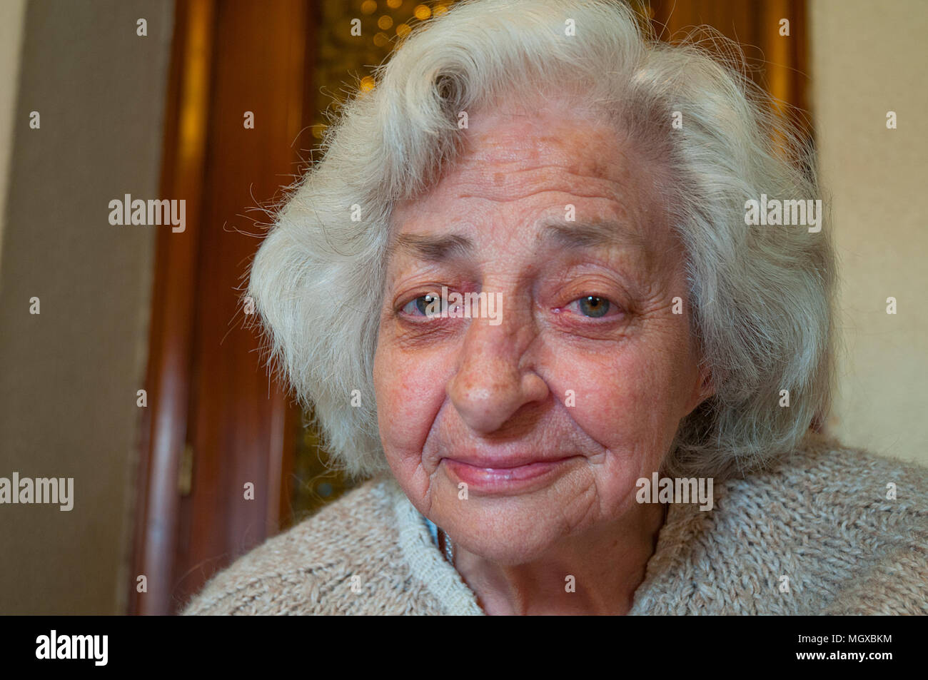 Old lady smiling and looking at the camera. Stock Photo