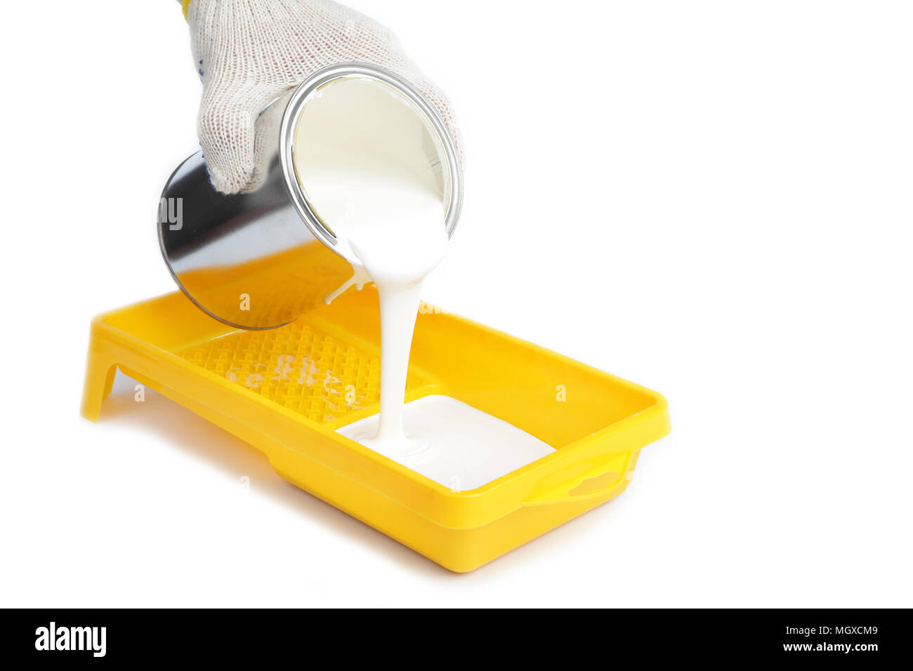 Pouring white paint into the tray Stock Photo Alamy