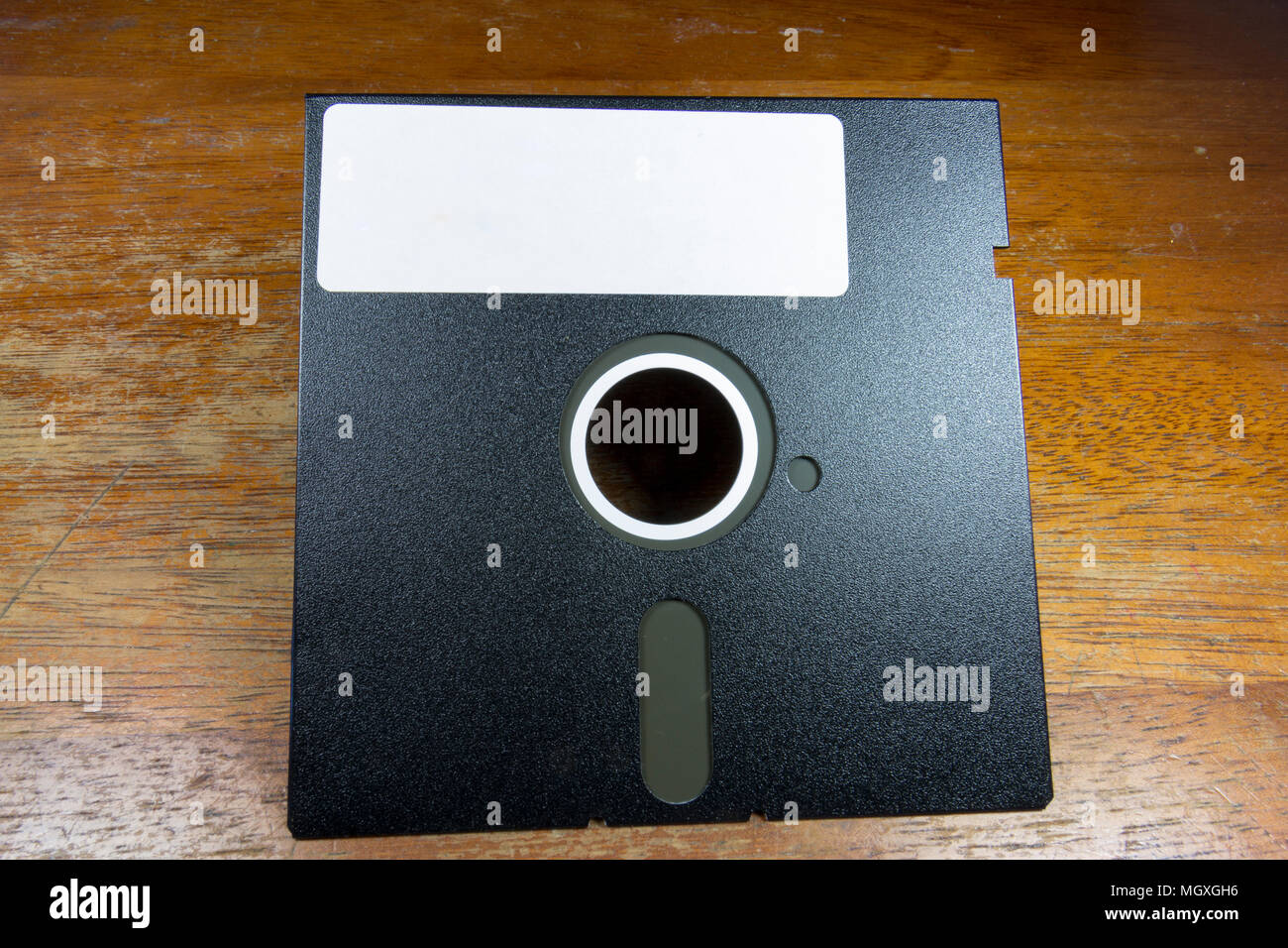 A 5¼-inchfloppy disk sitting on a table. Stock Photo
