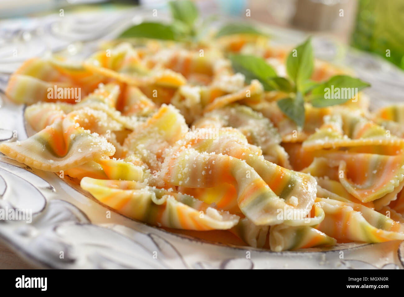 Farfalle pasta with parmesan cheese and basil Stock Photo