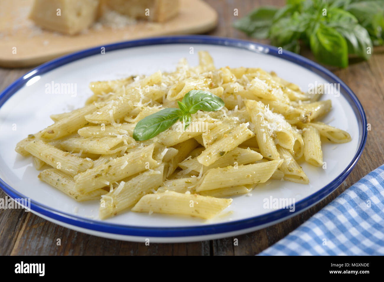 Macaroni with Parmesan cheese and basil leaf Stock Photo