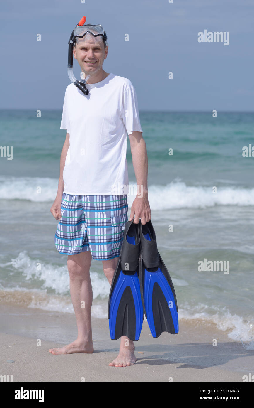 Man with mask, flippers, and snorkel against a sea Stock Photo - Alamy