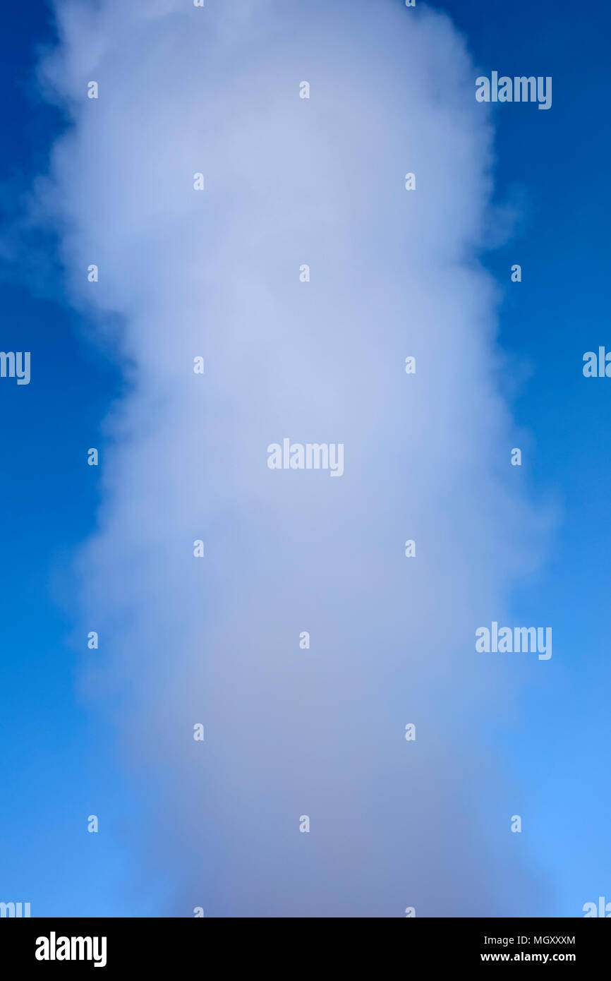 View at geyser steam eruption under the blue sky Stock Photo - Alamy