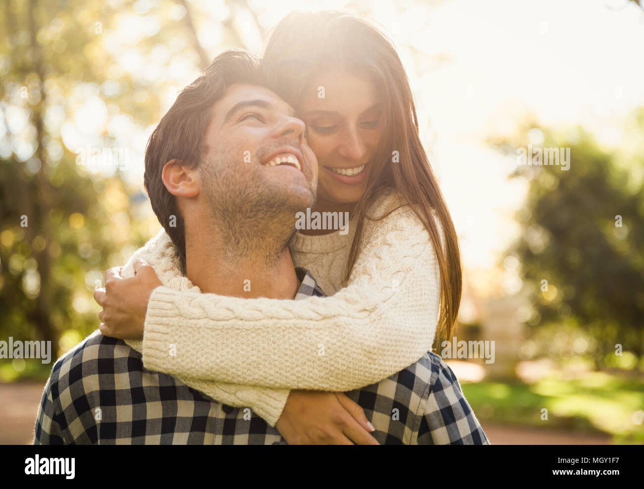 Beautiful couple in the park smiling Stock Photo