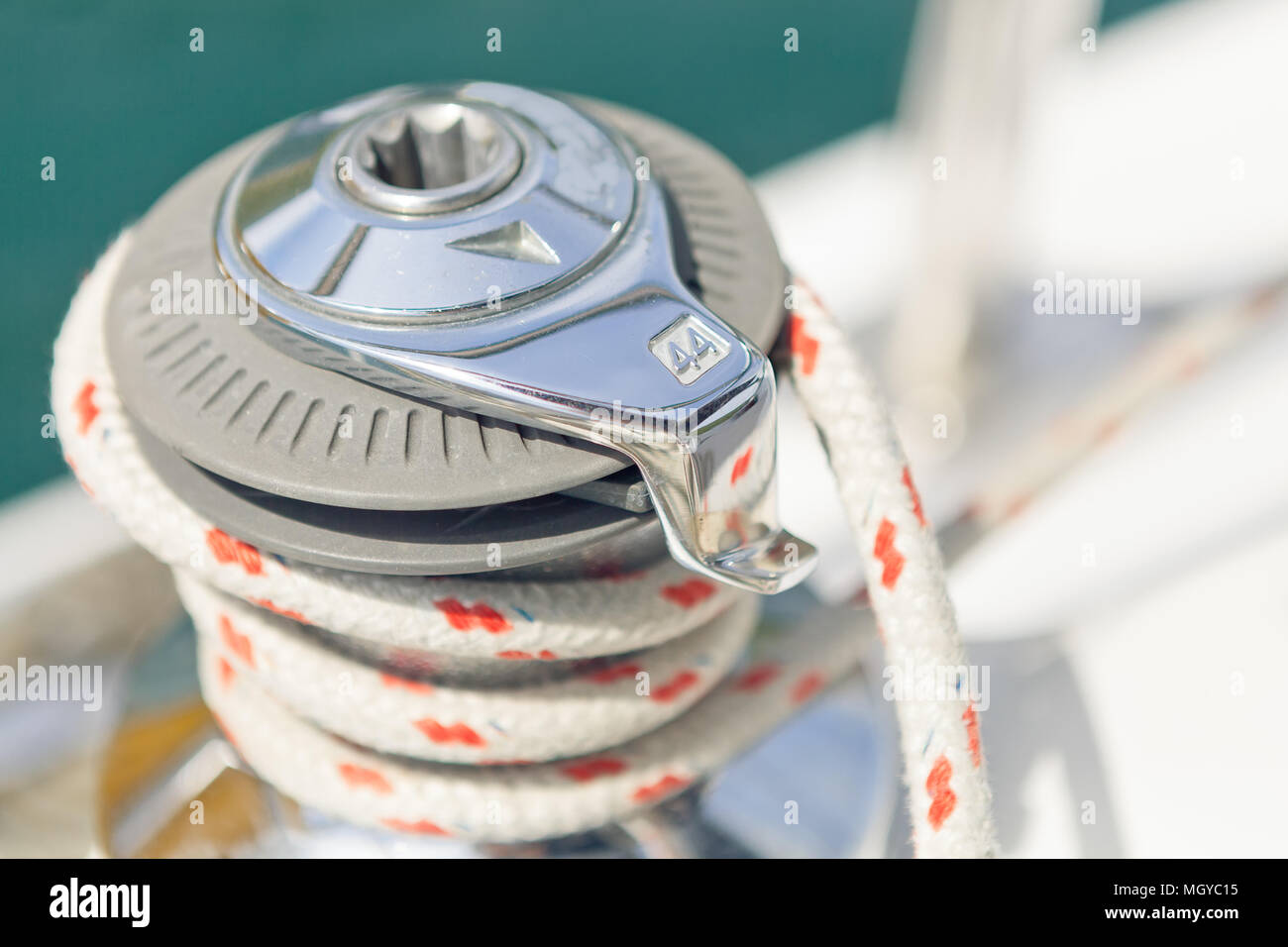 Close up on winch and rope of yacht over blue sea. Yachting concept. Shallow depth of field Stock Photo