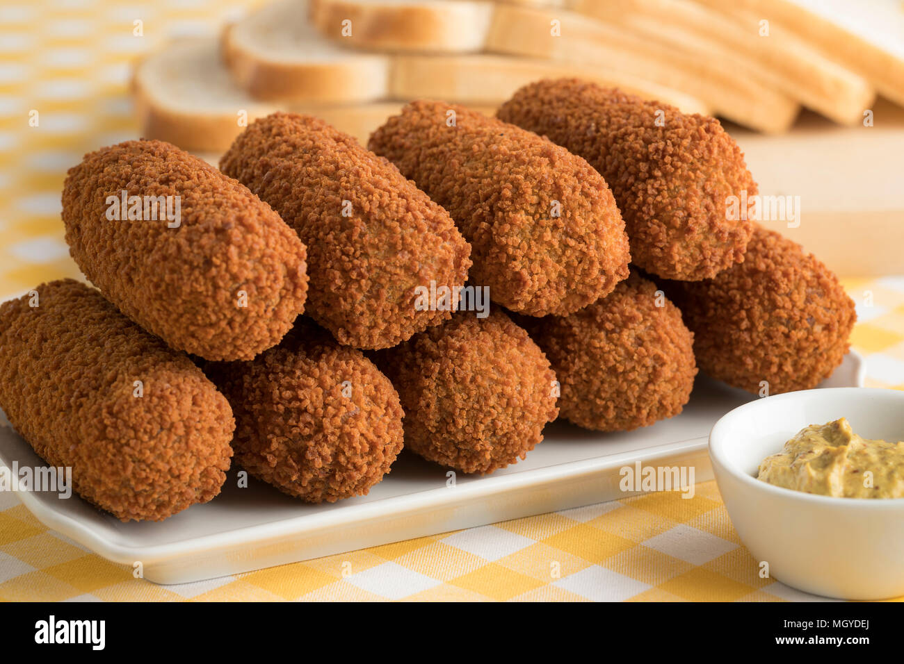 Deep fried Dutch kroketten and mustard for lunch Stock Photo