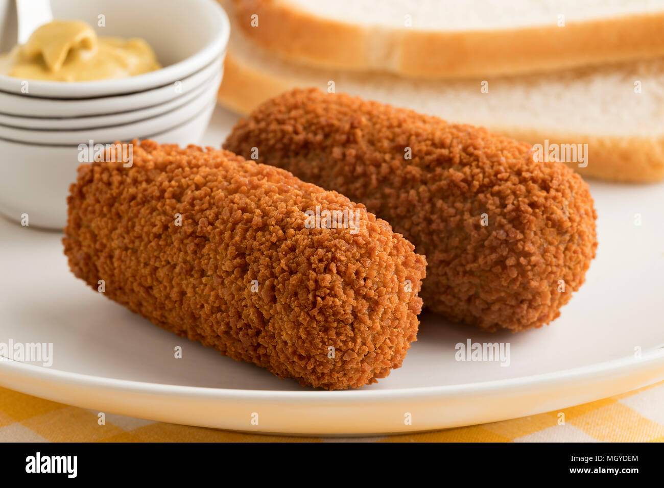 Deep fried Dutch kroketten and mustard for lunch Stock Photo