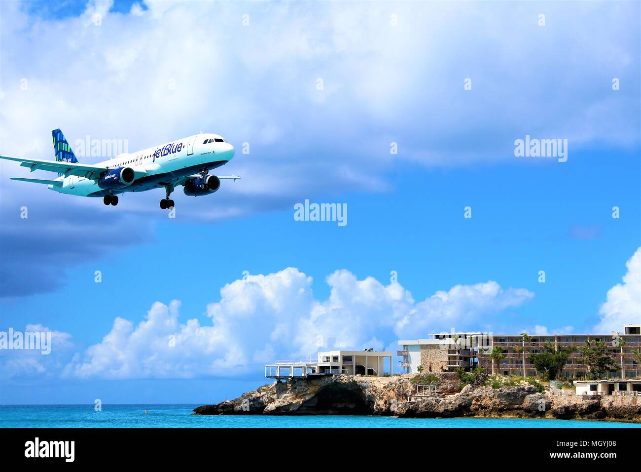 MAHO, ST MAARTEN - FEBRUARY 2018: A shot from Maho beach of a jetBlue passenger plane coming in to land at SXM Princess Juliana International Airport. Stock Photo