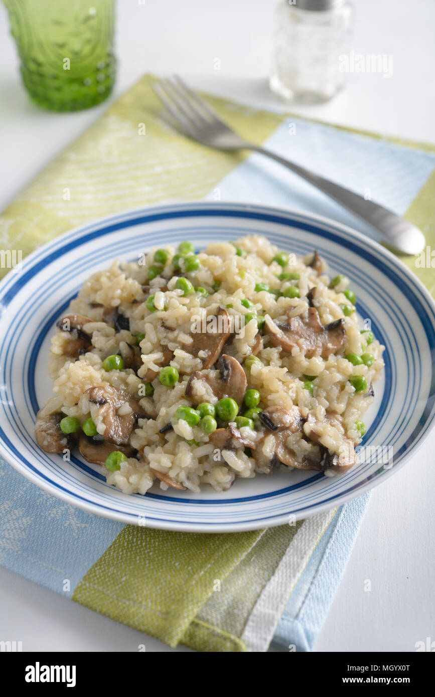Mushroom risotto with green peas Stock Photo Alamy
