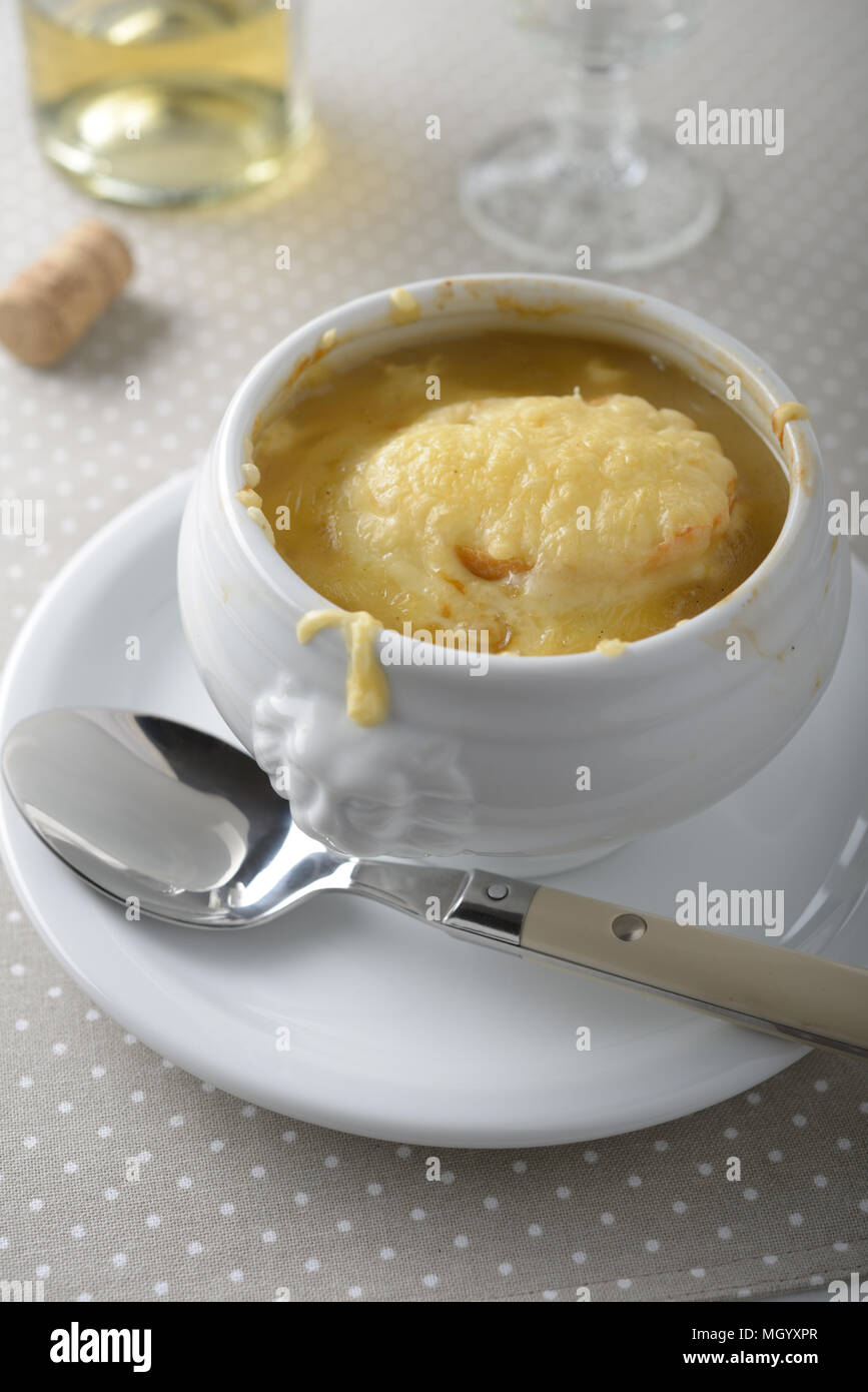 Onion soup in a white lion’s head bowl Stock Photo