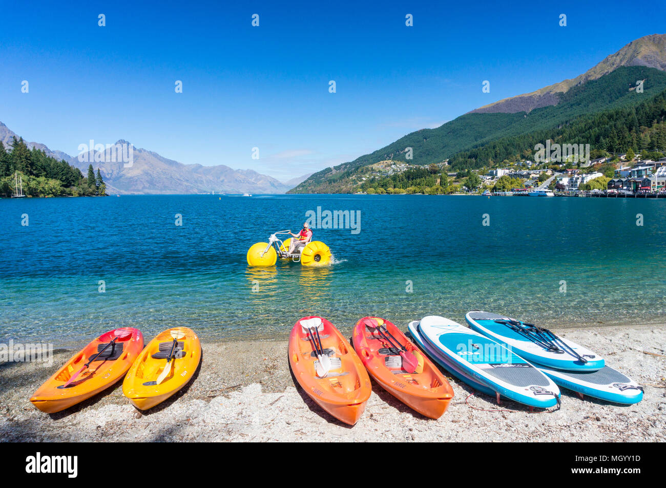 lake wakatipu from the lakeside with kayaks and water bicycles for hire and for rent rental kayaks lakeside queenstown South Island New Zealand Stock Photo