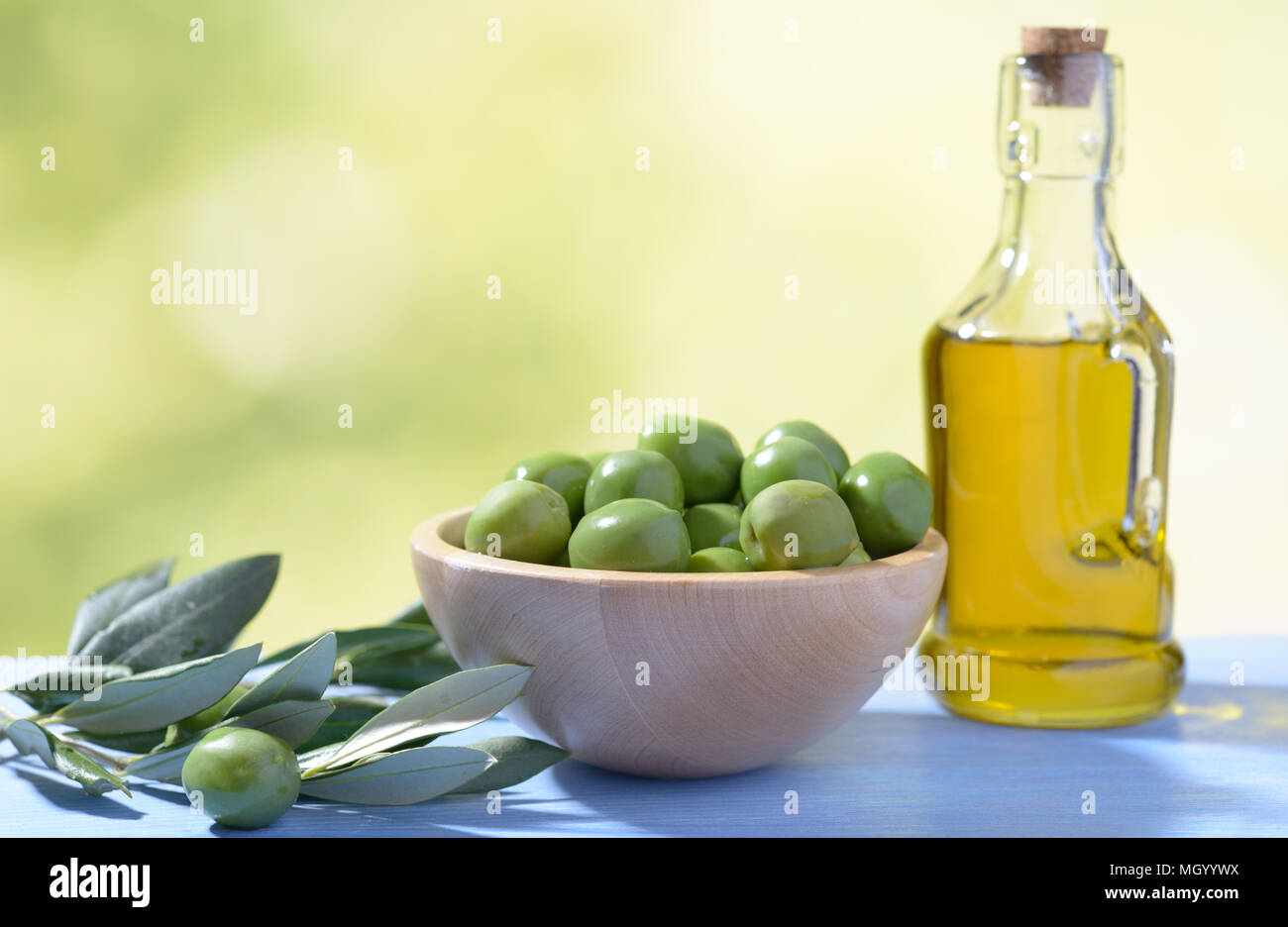 Green olives and olive oil Stock Photo - Alamy