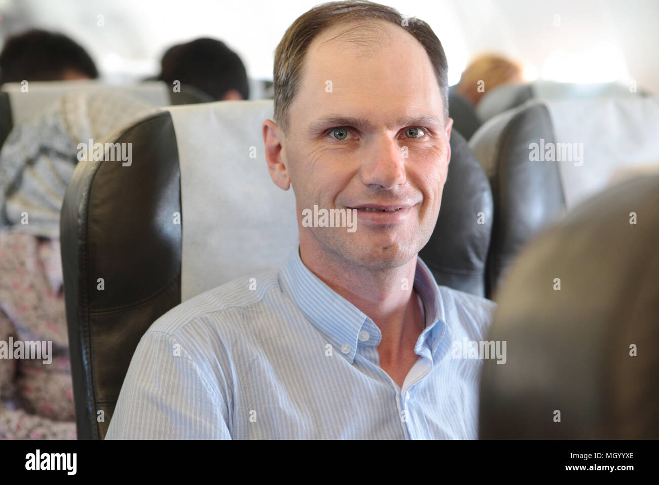 Mature man in the aircraft seat Stock Photo