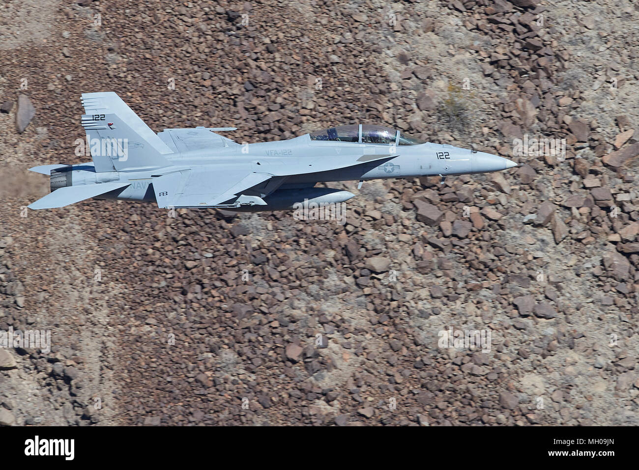 Close Up In Profile Photo Of A United States Navy F/A-18F Super Hornet Jet Fighter Flying At Low Altitude Through Rainbow Canyon California, USA. Stock Photo