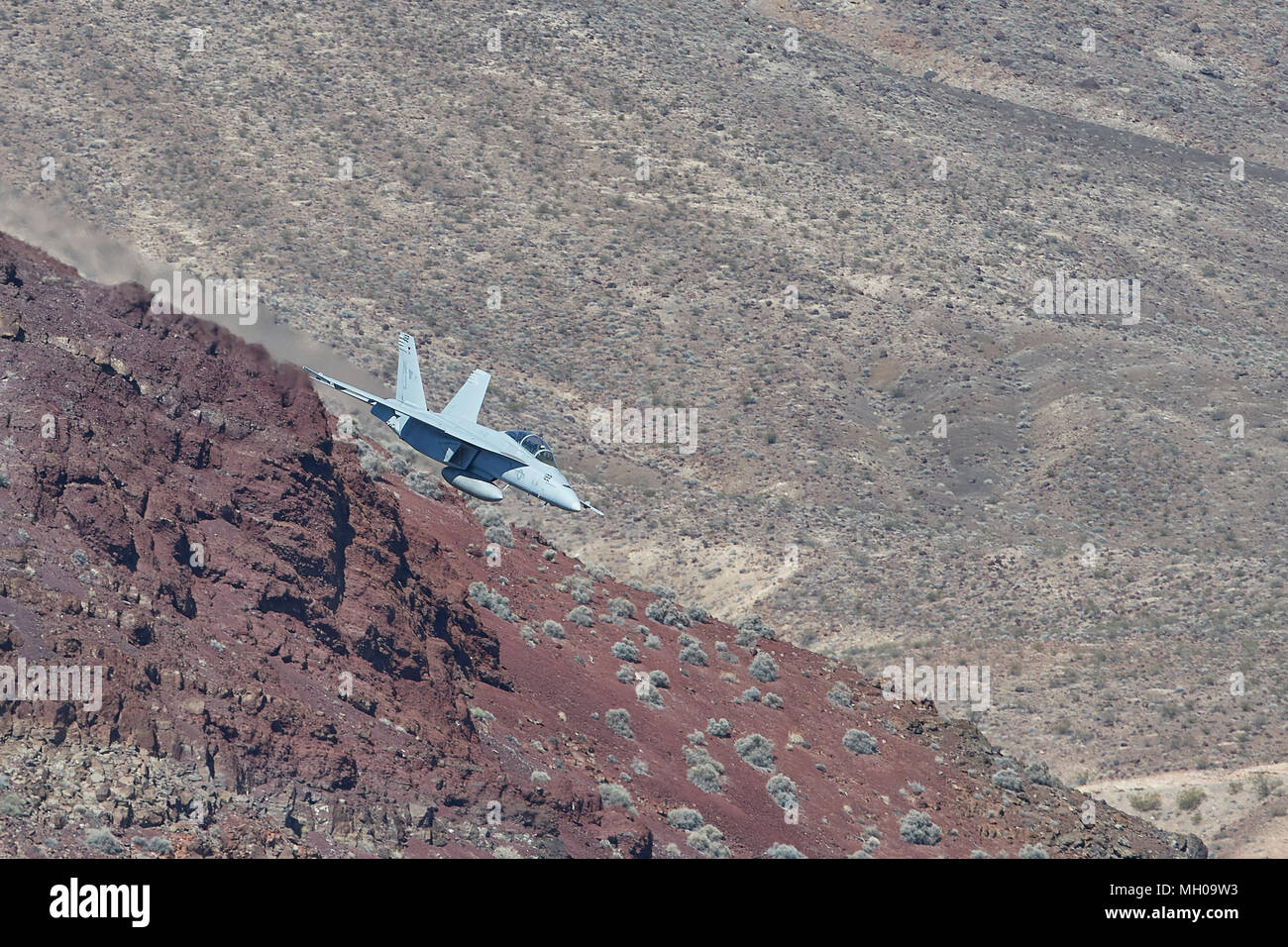 US Navy F/A-18F Super Hornet Jet Fighter Flying At Low Level Through Rainbow Canyon California, USA. Stock Photo