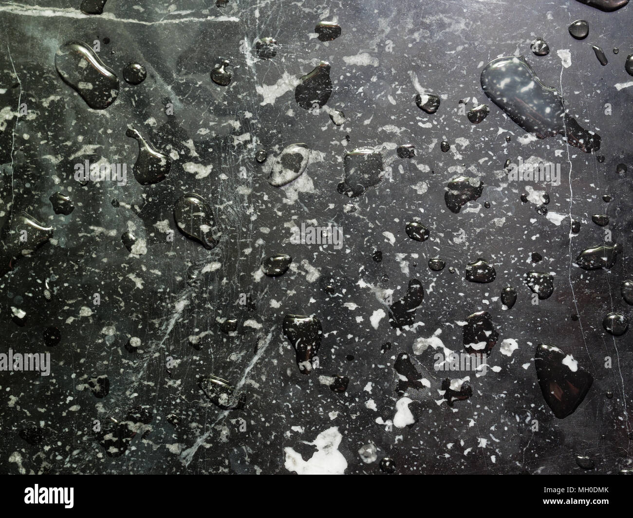 Black and white marble texture in abstract style with water drops, drips and splash, used as background in monotone, vintage, retro, grunge, artistic and abstract theme Stock Photo