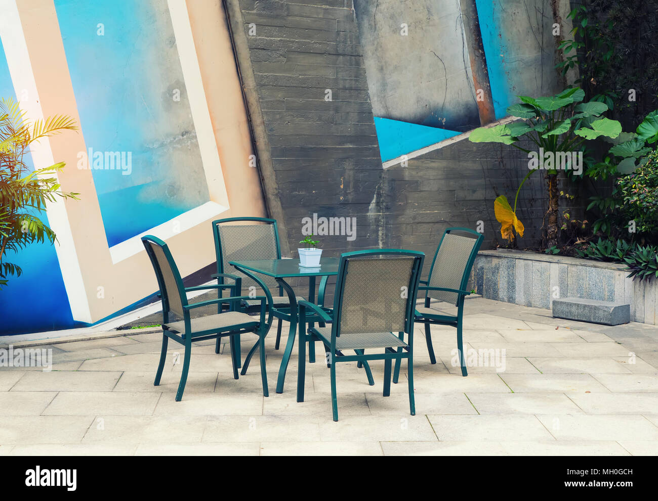 Outdoor desk and chairs near the wall Stock Photo Alamy