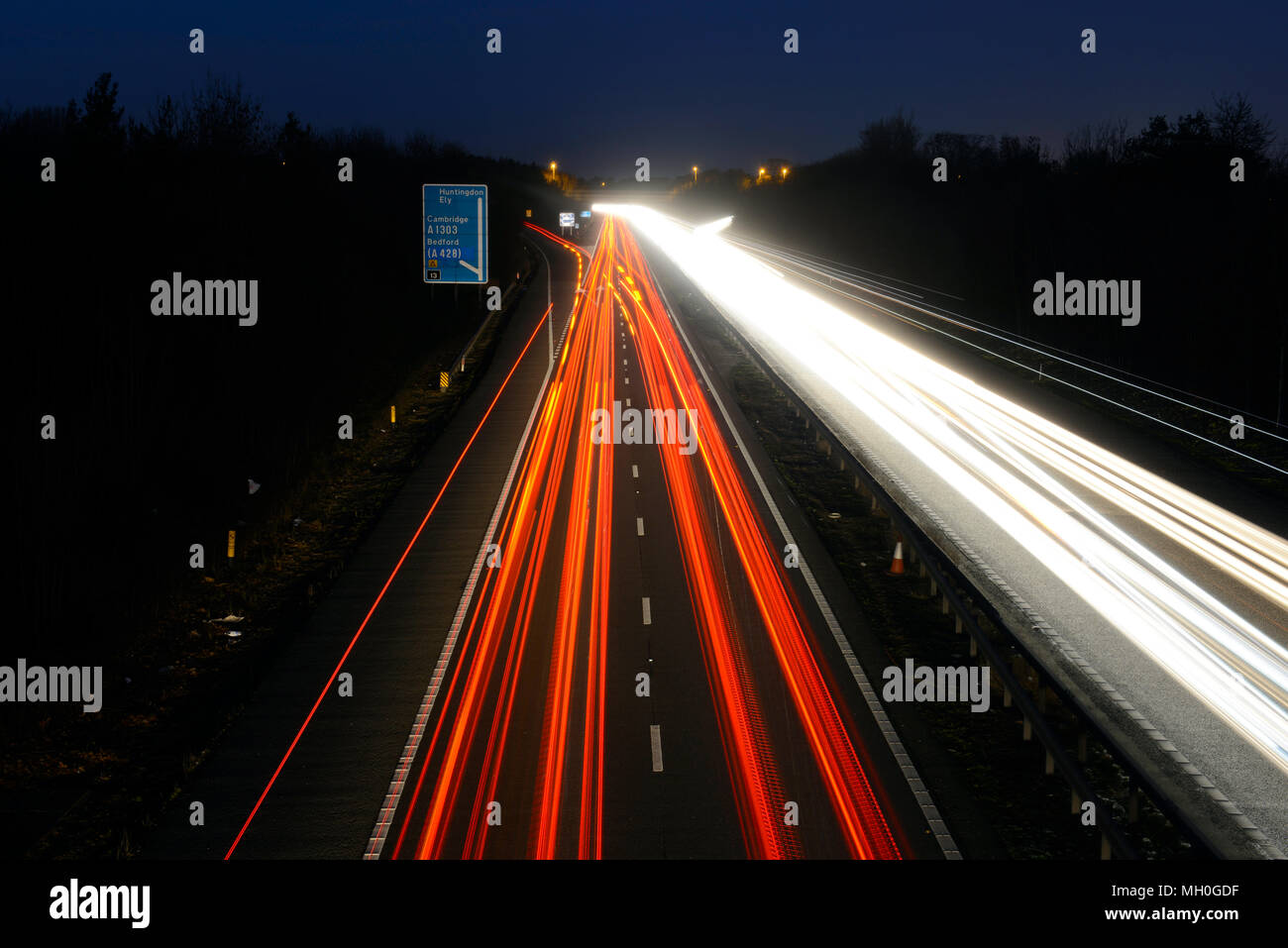 White headlights and red taillights on motorway at night in motion