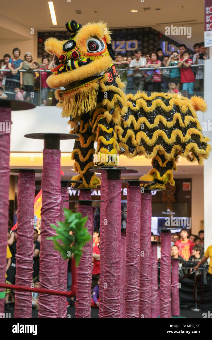 Lion dance performance on high pole at VIVA HOME shopping mall in Kuala