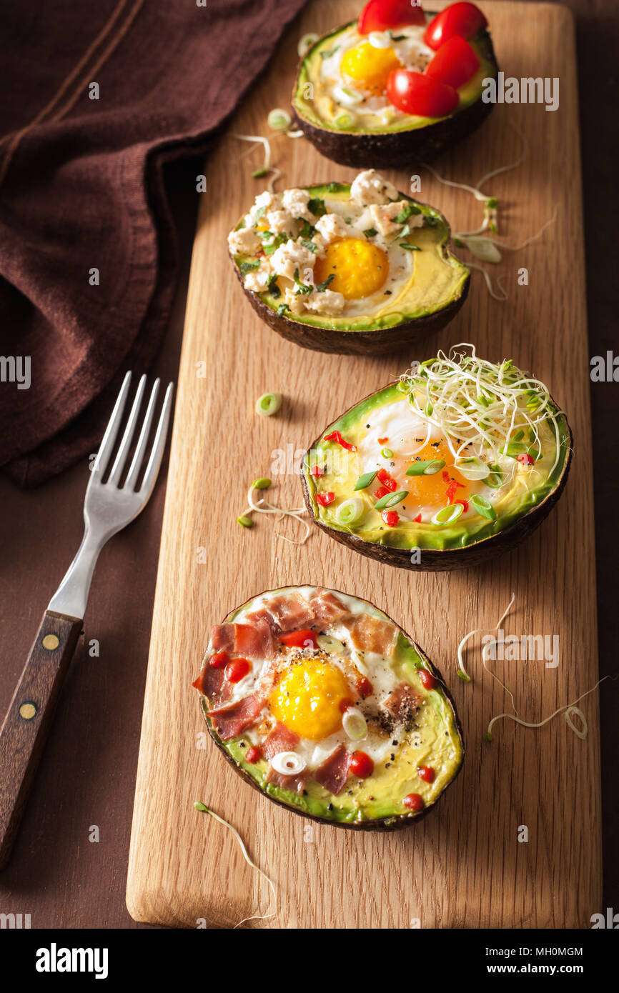 eggs baked in avocado with bacon, cheese, tomato and alfalfa sprouts