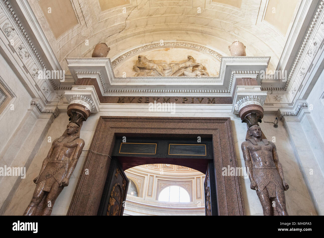 Egyptian statues and the bronze statue of Hercules in the Museo Pio-Clementino at the Vatican Museums Stock Photo