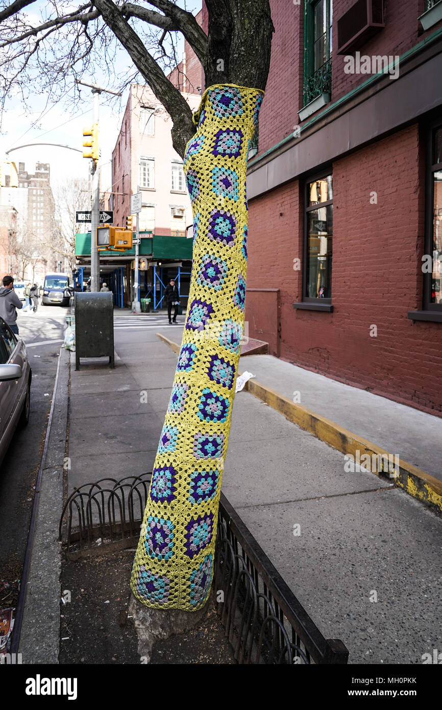 A view of a tree trunk wrapped in a knitted garment in Greenwich Village, Manhattan. From a series of travel photos in the United States. Photo date:  Stock Photo
