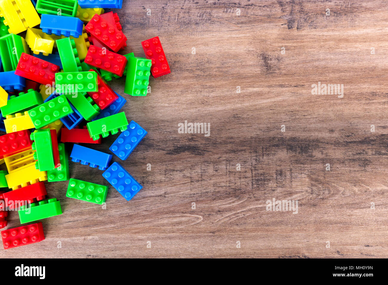Top view of colorful toy building blocks on wood background with copy space Stock Photo