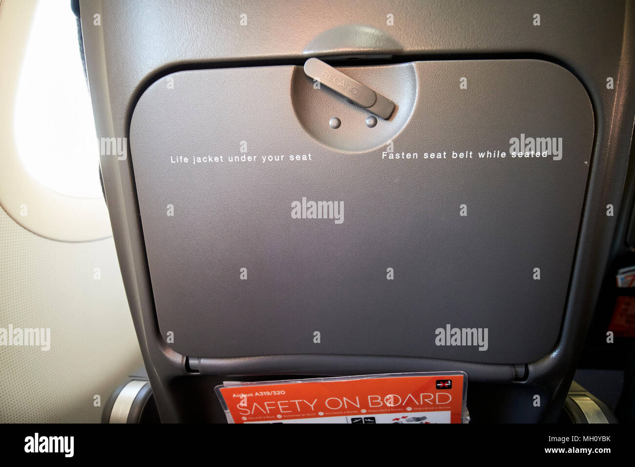 stowed table on back of easyjet airplane seat bristol airport england uk Stock Photo